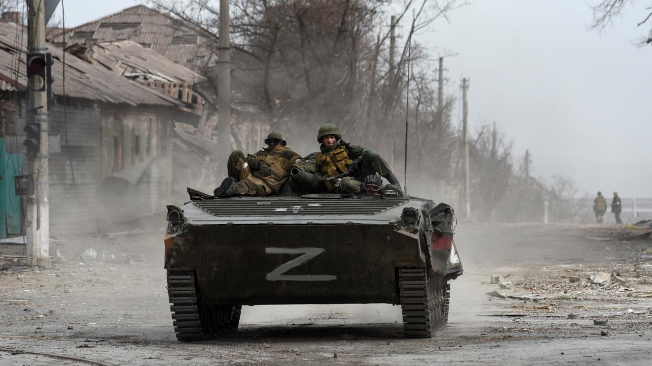 Service members of pro-Russian troops sit atop of an armoured vehicle, which moves along a street in the course of Ukraine-Russia conflict in the southern port city of Mariupol, Ukraine April 1. REUTERS/Stringer