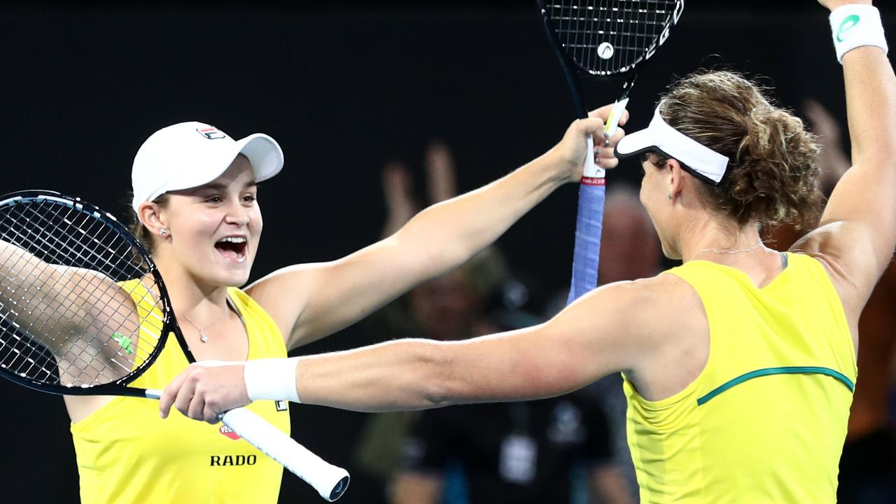 Samantha Stosur and Ashleigh Barty celebrate winning their doubles match.