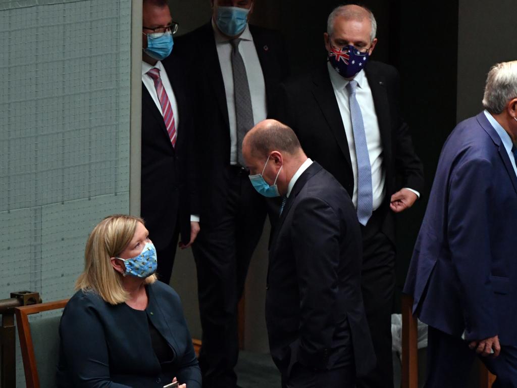 Scott Morrison enters the chamber as Bridget Archer speaks to Josh Frydenberg after crossing the floor during a vote on Thursday, November 25, 2021. Picture: Mick Tsikas/AAP