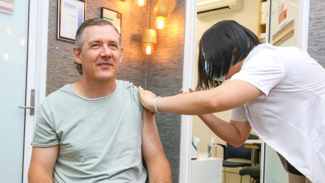 NT Chief Minister Michael Gunner receives his Covid-19 vaccination booster shot at a pharmacy. Picture: Glenn Campbell