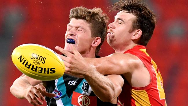 Mitch Georgiades (left) in action in the win over the Suns. Picture: AAP Image/Darren England.