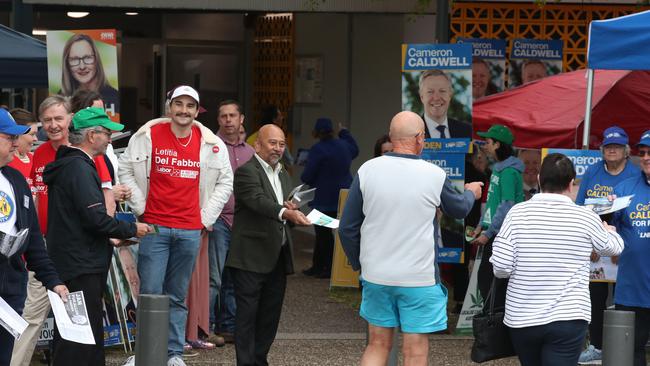 Candidates and their supporters greet voters at Runaway Bay Sports Centre when pre-poll voting opened for the seat of Fadden on Monday morning. Picture Glenn Hampson