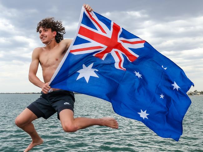 Kayne Razmovski 16yrs flys the Australian flag at Altona. Picture Ian Currie