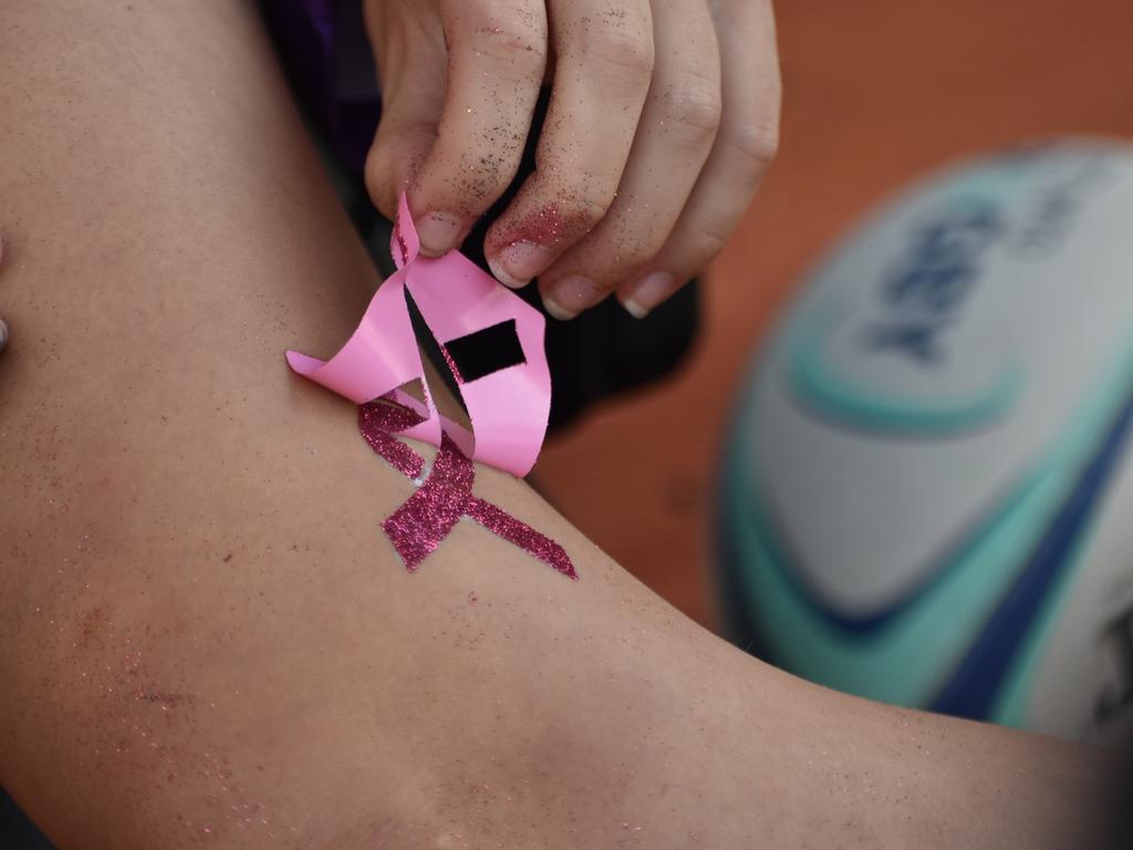 Ella Clulee making glitter tattoos in the shape of the breast cancer ribbon at the Mackay Pioneer Valley Relay For Life, September 2021. Picture: Lillian Watkins