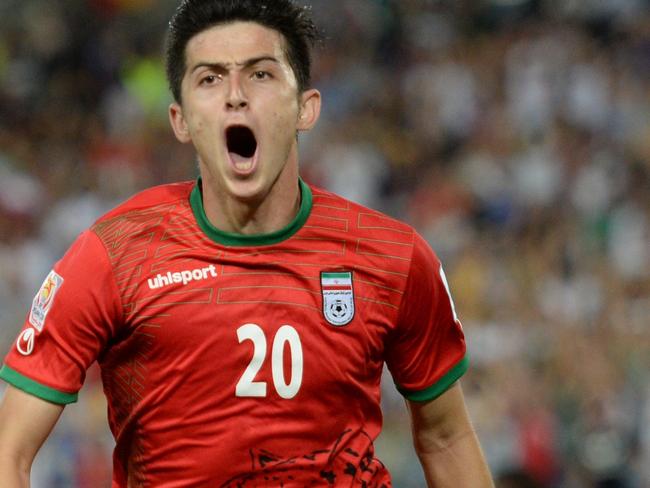 Sardar Azmoun of Iran (C) celebrates scoring the opening goal against Qatar in their Group C football match in the AFC Asian Cup in Sydney on January 15, 2015. AFP PHOTO/Peter PARKS --IMAGE RESTRICTED TO EDITORIAL USE - STRICTLY NO COMMERCIAL USE