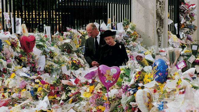 Queen Elizabeth and Prince Philip view the floral tributes to Princess Diana at Buckingham Palace in 1997.