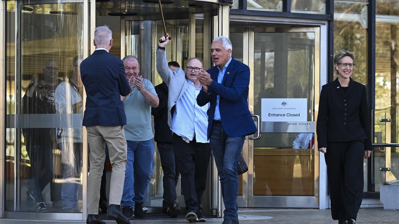 Workers, their families and union officials cheer as they walk out of the High Court in Canberra. Picture: NCA NewsWire / Martin Ollman