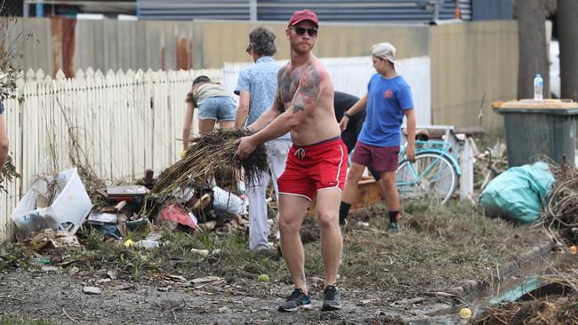 The clean-up is under way at Vincent St in Auchenflower. Picture: Annette Dew