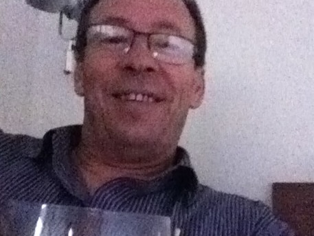 MP Peter Dowling with a glass of red wine.