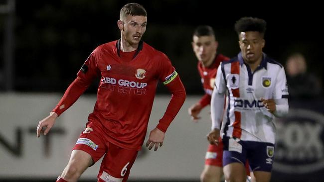 Harry Monoghan looks to play forward against Central Coast Mariners.