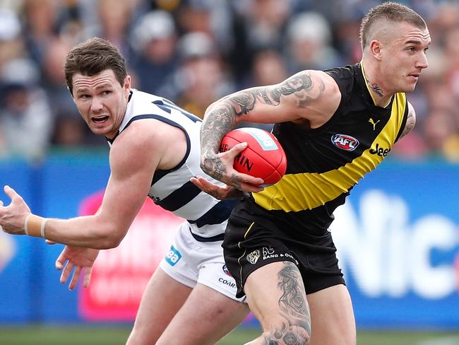 GEELONG, AUSTRALIA - AUGUST 12: Dustin Martin of the Tigers in action ahead of Patrick Dangerfield of the Cats during the 2017 AFL round 21 match between the Geelong Cats and the Richmond Tigers at Simonds Stadium on August 12, 2017 in Geelong, Australia. (Photo by Adam Trafford/AFL Media/Getty Images)