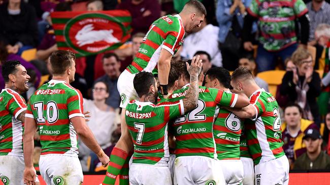 Damien Cook is congratulated by Rabbitohs teammates after scoring a try. Picture: Getty Images