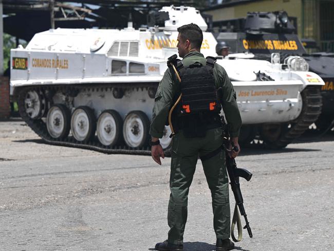 Armored vehicles are seen near the Tocoron prison after authorities seized control of the prison in Tocoron, Aragua State, Venezuela, on September 20, 2023. Venezuela said Wednesday it had seized control of a prison from the hands of a powerful gang with international reach, in a major operation involving 11,000 members of its security forces. (Photo by YURI CORTEZ / AFP)