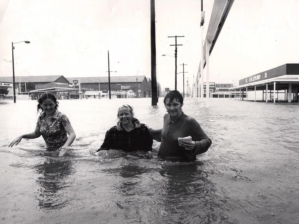 Three nurses on way to work at RBH wade through water. outside Perrots in Bowen Bridge Road.