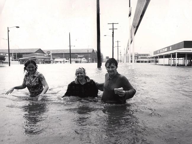 Three nurses on way to work at RBH wade through water. outside Perrots in Bowen Bridge Road.