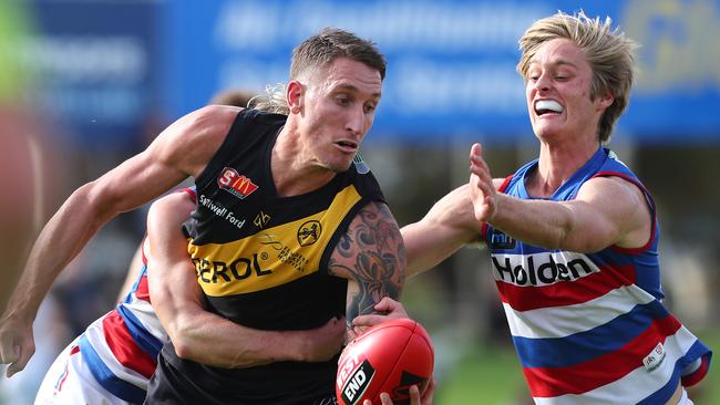 Central District draft prospect Jackson Hately applies pressure to Glenelg’s Jesse White. Picture: Tait Schmaal