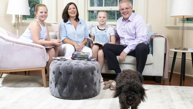 The schnoodle is a much-loved member of the Morrison family — Abbey 11, Jenny, Lily, 9, and Scott with Buddy. Picture: Darren Leigh Roberts