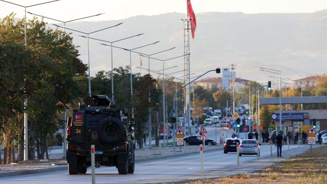 An armoured personnel vehicle moves toward the gate of the Turkish Aerospace Industries (TAI), after the attack. Picture: AFP.