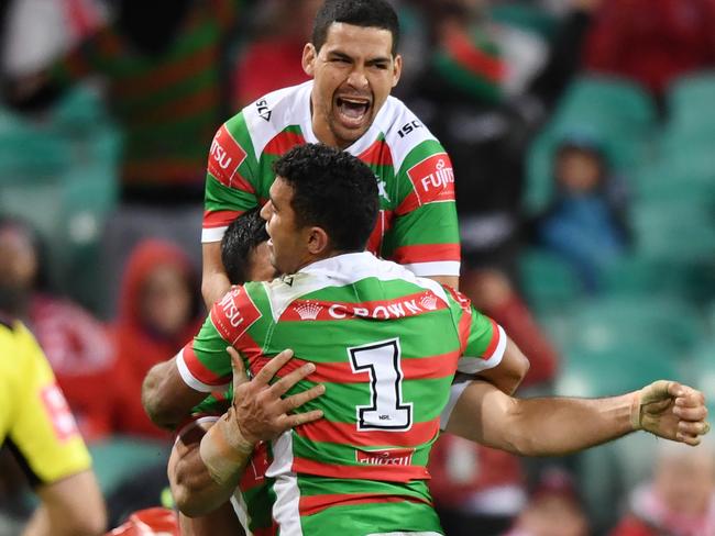 Cody Walker celebrates a try with teammates.