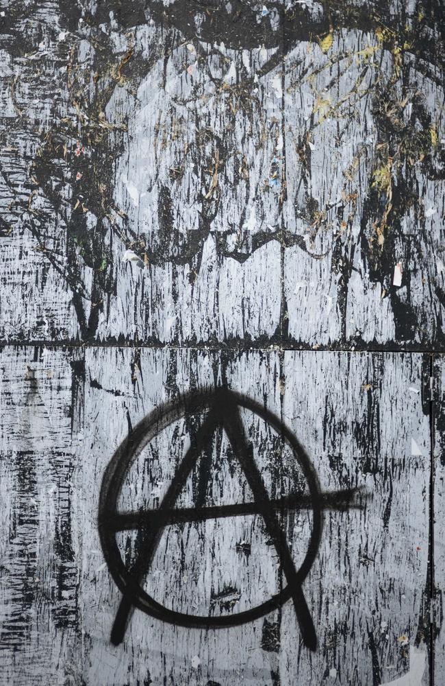 The A for anarchy symbol, is painted on a wall near by the Madeleine church in Paris. Picture: AP