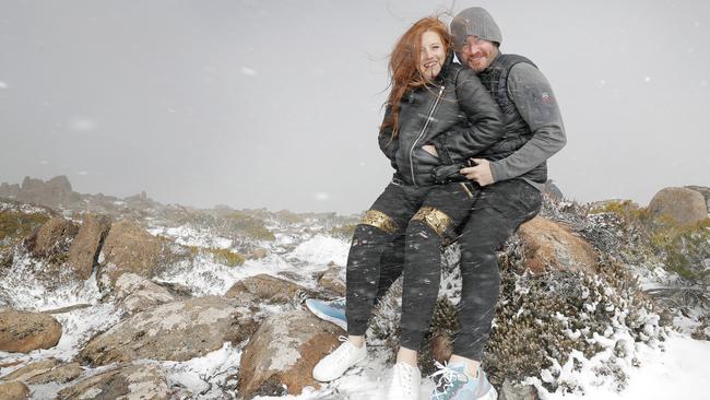 Alyssa Belezos and Nic Van Der Breggen from Sydney get a taste of Hobart's wild weather on kunanyi/Mt Wellington yesterday. Picture: PATRICK GEE