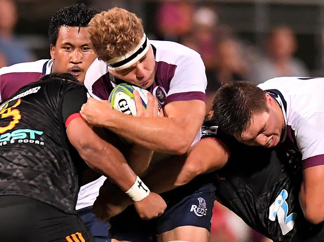 BRISBANE, AUSTRALIA - FEBRUARY 08: Angus Scott-Young of the Reds is tackled during the Super Rugby pre-season match between the Reds and the Chiefs at Ballymore Stadium on February 08, 2019 in Brisbane, Australia. (Photo by Albert Perez/Getty Images)