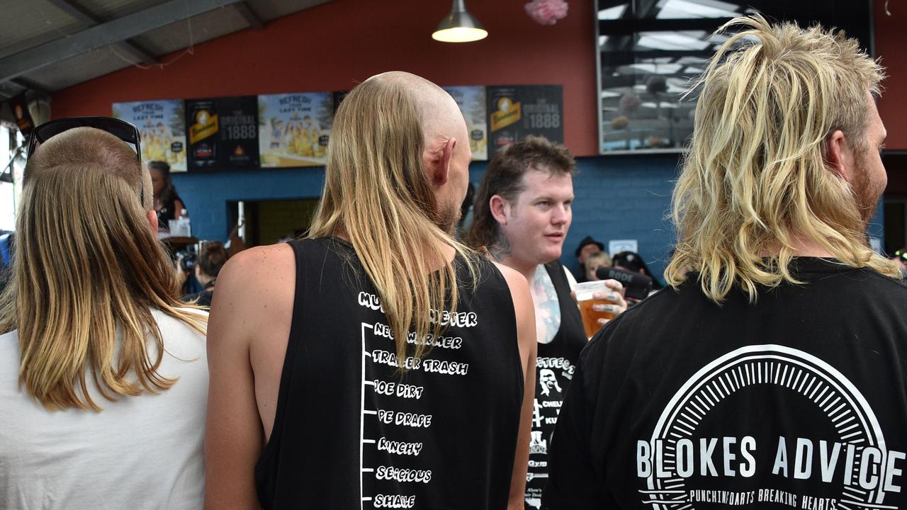 Men wait to be judged on their mullet hairstyles at Mulletfest. Picture: Peter Parks.
