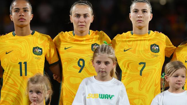 PERTH, AUSTRALIA - NOVEMBER 01: Mary Fowler, Caitlin Foord , Steph Catley, Clare Wheeler and Kyra Cooney-Cross of the Matildas line up for the national anthem during the AFC Women's Asian Olympic Qualifier match between Australia Matildas and Chinese Taipei at HBF Park on November 01, 2023 in Perth, Australia. (Photo by James Worsfold/Getty Images)