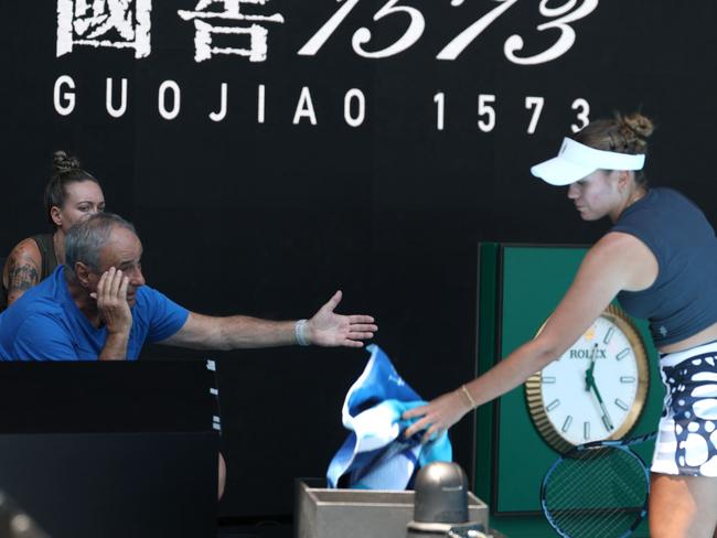 USA's Sofia Kenin (R) consults her coach, Alexander Kenin, seated in the court-side coaching pods during her women's singles match against compatriot Coco Gauff on Day 2 of the Australian Open in Melbourne, January 13, 2025. (Photo by DAVID GRAY / AFP) / -- IMAGE RESTRICTED TO EDITORIAL USE - STRICTLY NO COMMERCIAL USE --