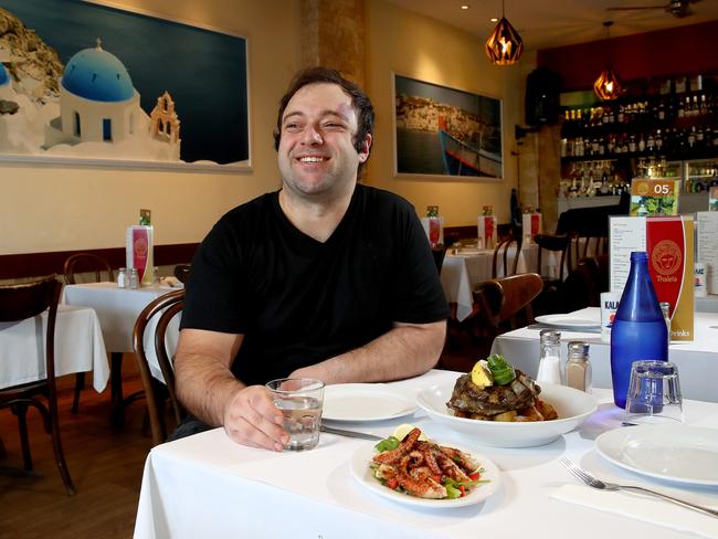 Thaleia Greek restaurant owner Josip Devcic pictured with an entree of octopus and main course of lamb. Picture: Toby Zerna