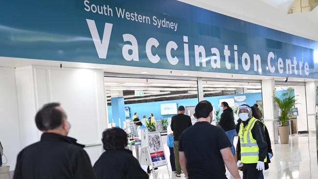 People line up at the Vaccination Centre inside the Glenquarie shopping centre in Macquarie Fields, Sydney. Picture: NCA NewsWire/Jeremy Piper