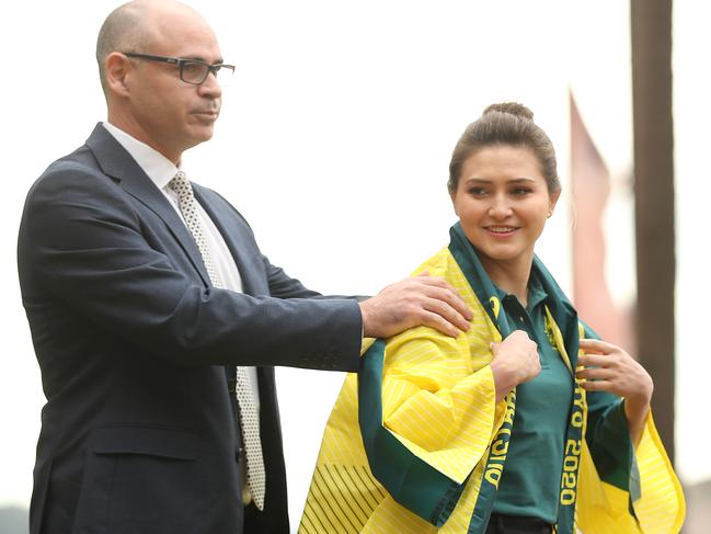 Diving Australia president Michael Murphy presents a Tokyo robe to Melissa Wu. Picture: Mark Metcalfe/Getty Images