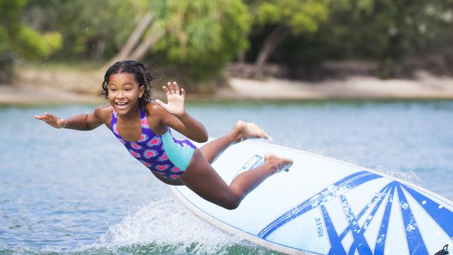 8 year old Kiri Todhunter from Ninderry kicked off her school holidays with a splash at Noosa River, followed by fish and chips on the beach. Photo Lachie Millard