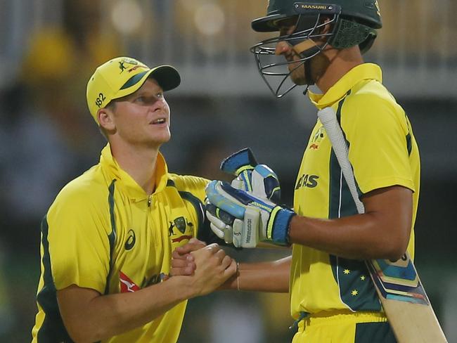 Australia's captain Steve Smith, second right, congratulates Mitchell Starc, right, after defeating Sri Lanka by three wickets during their first one day international cricket match in Colombo, Sri Lanka, Sunday, Aug. 21, 2016. (AP Photo/Eranga Jayawardena)