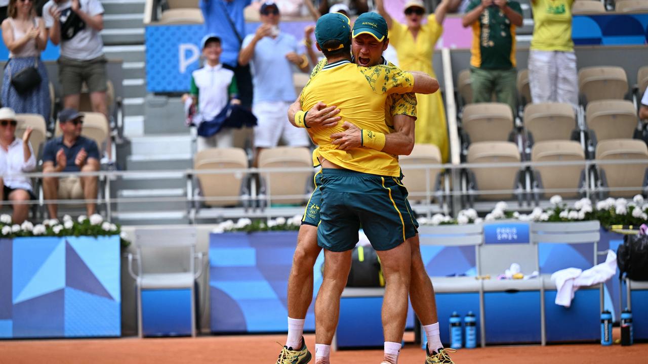 Australia's Matthew Ebden (R) and Australia's John Peers (L) embrace as they celebrate beating US' Austin Krajicek and US' Rajeev Ram.