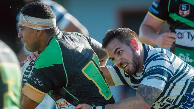 Stephen Smith tackled by Matthew Bennett as Raiders take on the Darwin Brothers. Picture: GLENN CAMPBELL