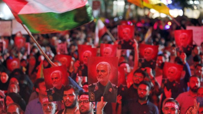 Iranians carry pictures of slain Revolutionary Guard commander Qasem Soleimani as they attend a gathering in Tehran on Saturday to express their solidarity with Palestinians after Hamas militants launched a deadly assault into Israel from the Gaza Strip. Picture: AFP