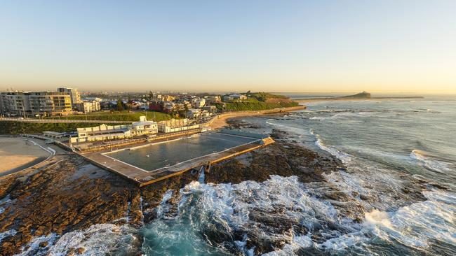 Aerial view of the Newcastle Ocean Baths in the morning light looking over the city of Newcastle. Escape 18 August 2024 Why I Travel Photo - iStock