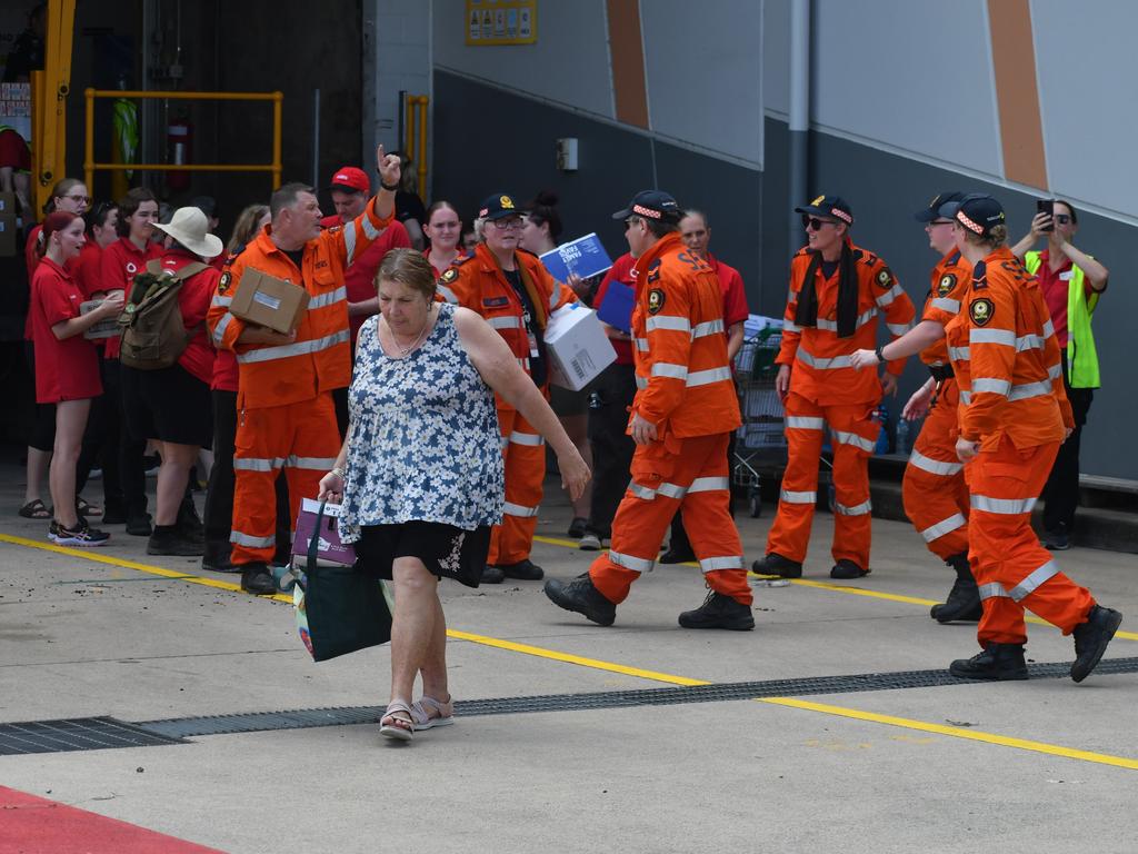 Coles and SES personnel are pictured donating free groceries to flood-struck residents in Ingham, North Queensland. Picture: Cameron Bates