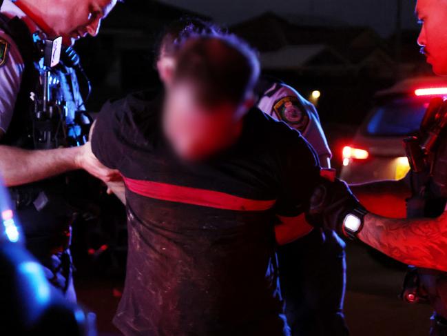 Police have charged almost 600 people with serious domestic violence offences, during a four-day high-visibility operation targeting the state’s most high-risk domestic violence offenders., , Pictured: Mt Pritchard arrest, , Operation Amarok V, an intelligence-based policing strategy led by each region’s Domestic Violence High-Risk Offender Teams (DVHROT), ran from Wednesday to Saturday (7 – 10 February 2024)., , Officers from all police area commands and police districts in NSW, as well as various proactive and specialist units, were involved in the operation., , A total of 590 people were arrested, and 1183 charges laid during the first Amarok of 2024. Of those arrested, 229 were wanted by police for serious domestic violence offences. Photo: NSW Police