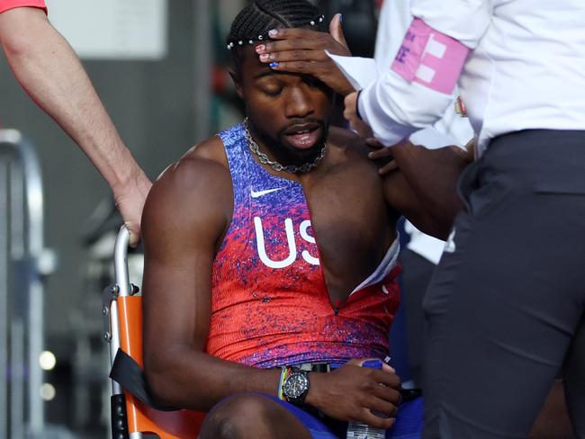 PARIS, FRANCE - AUGUST 08: Bronze medalist Noah Lyles of Team United States is taken off from the track with a wheelchair after competing in the Men's 200m Final on day thirteen of the Olympic Games Paris 2024 at Stade de France on August 08, 2024 in Paris, France. (Photo by Christian Petersen/Getty Images)