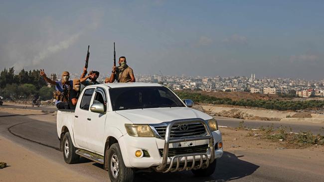 Palestinian militants move towards the Erez crossing between Israel and the northern Gaza Strip on October 7. Picture: AFP