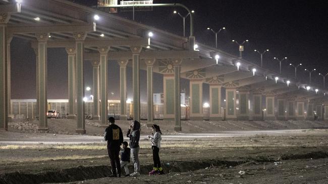 A Mexican family stands along the bank of the Rio Grande at the US-Mexico border. Picture: John Moore/Getty Images