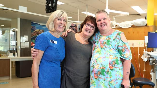 Founding director of COUCH Pip Woodward hugs breast cancer survivors Bridget Little and Debbie Arnold in the Liz Plummer day treatment clinic. Mrs Arnold was diagnosed with a primary brain tumour in January. Picture: Brendan Radke