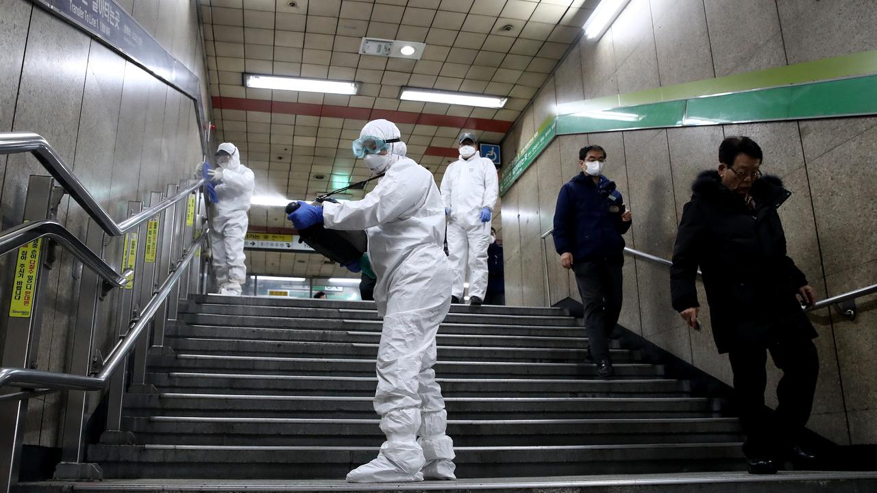 Disinfection workers wearing protective gear spray antiseptic solution against the at the subway station in Seoul, South Korea on February 21, 2020. Picture: Chung Sung-Jun/Getty Images