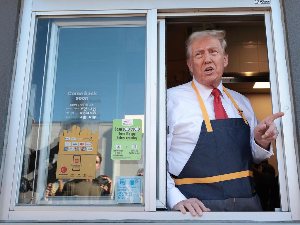 Donald Trump answers questions as he works the drive-through line at a McDonald’s in the crucial campaign state of Pennsylvania. Picture: AFP