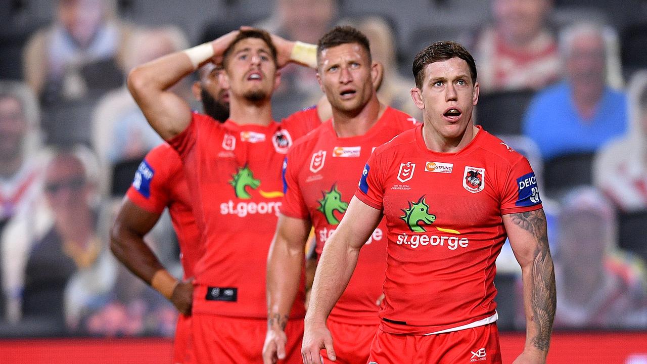 Cameron McInnes of the Dragons (right) reacts after his team conceded a try