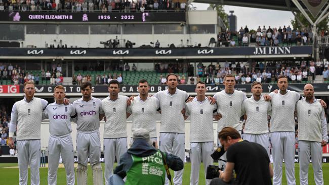 England's cricketers led by captain Ben Stokes (L) wear black armbands as they sing the national anthem 'God save the King'.