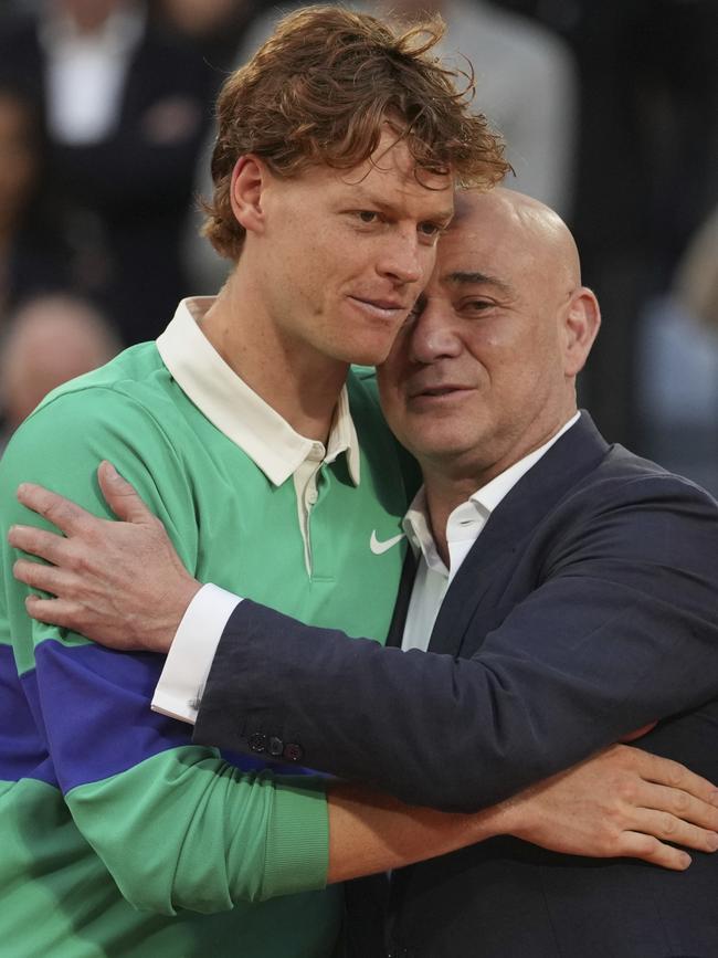 Andre Agassi, right, consoles Sinner. Picture: AP