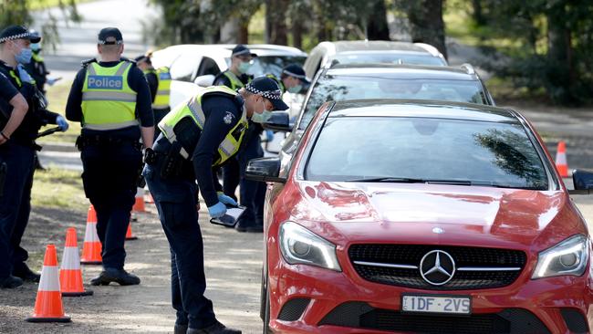 Police check travel permits at a mobile checkpoint at Eltham in Melbourne's outer north east as stage 4 lockdowns come into effect across the city in 2020. Picture: NCA NewsWire / Andrew Henshaw